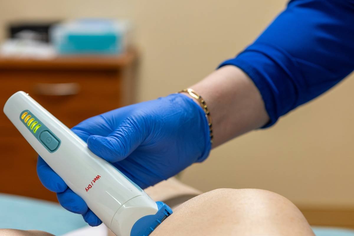 A person holding allergy friendly cosmetics labeled as hypoallergenic.