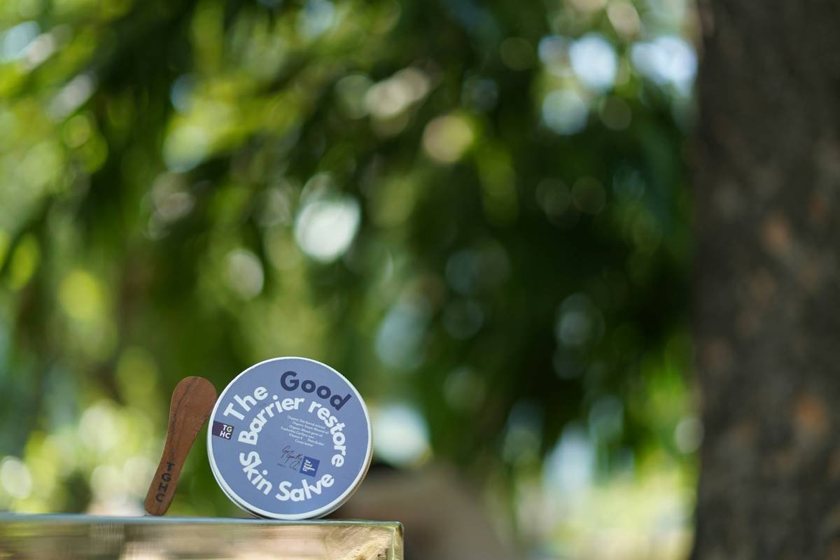 A flat lay featuring three bottles of mild makeup products including foundation, primer, and blush.