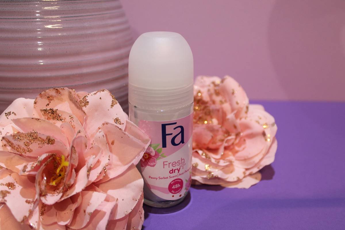 Woman applying non irritating deodorant for sensitive skin to clean, dry underarms in natural light