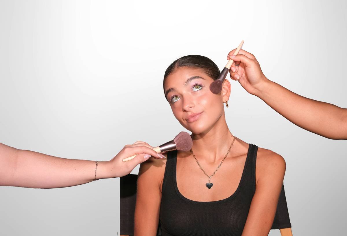 Woman applying mineral foundation with clean brush; irritation free sensitive skin is jane
